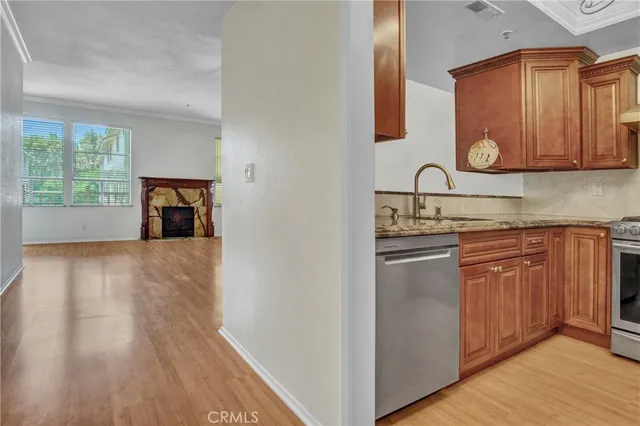 a kitchen with stainless steel appliances granite countertop a stove and a sink
