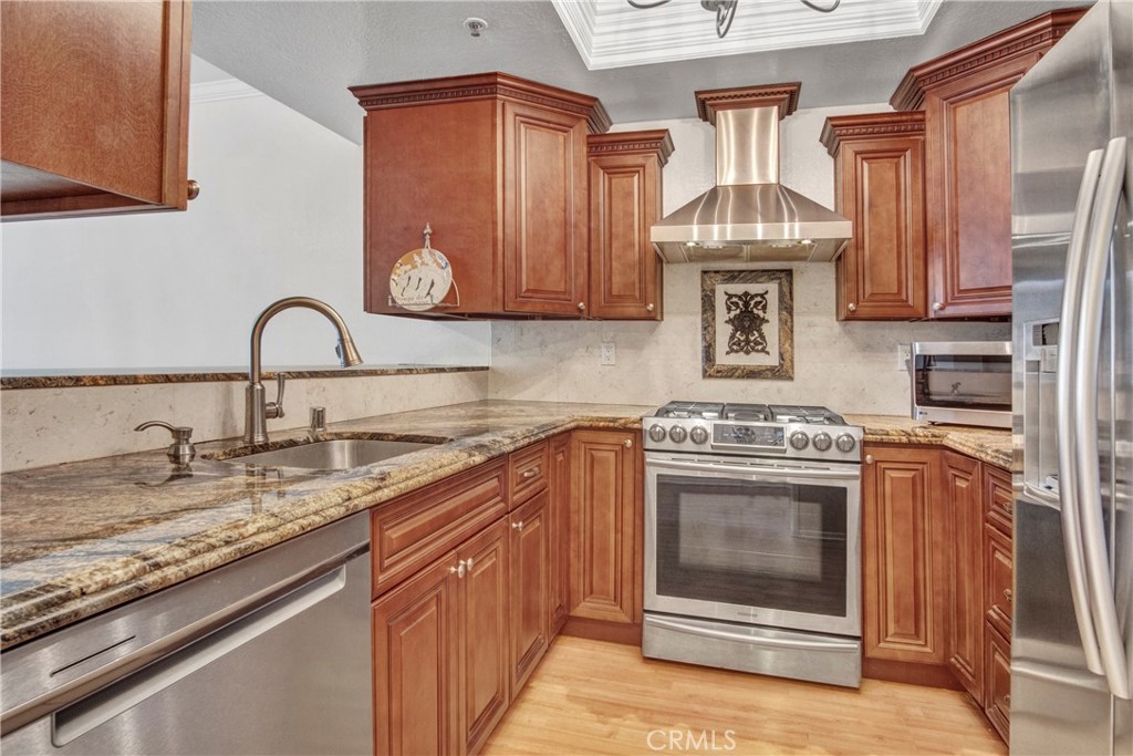 2571 Plaza Del Amo, Unit 107 Torrance, CA 90503 - Photo 9 of 33 a kitchen with stainless steel appliances granite countertop a stove and a sink