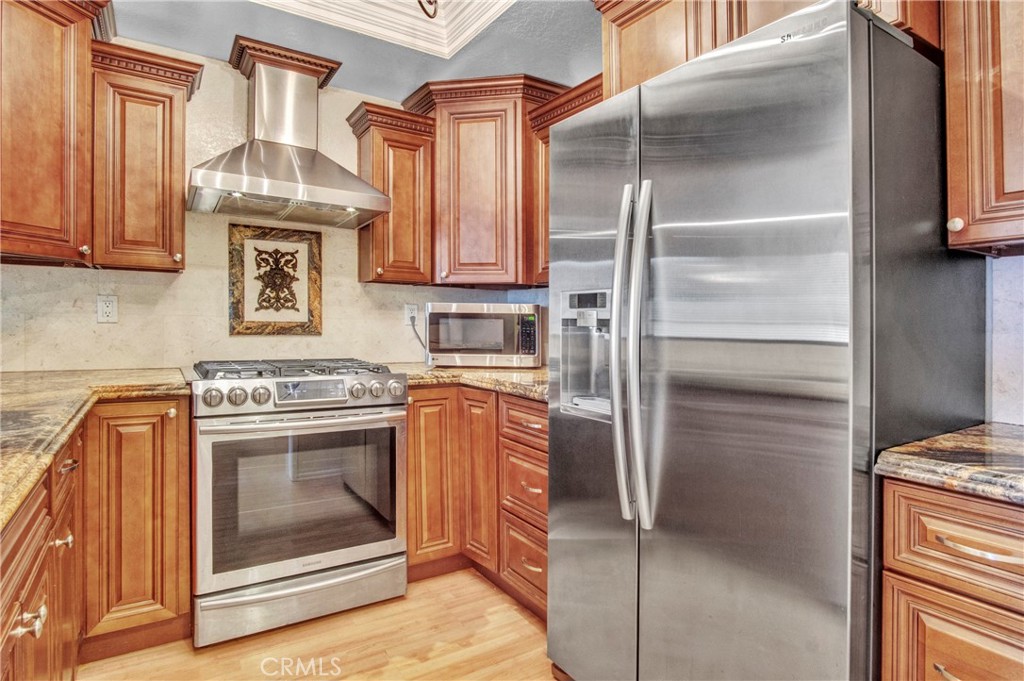 2571 Plaza Del Amo, Unit 107 Torrance, CA 90503 - Photo 10 of 33 a kitchen with stainless steel appliances granite countertop a stove and a refrigerator