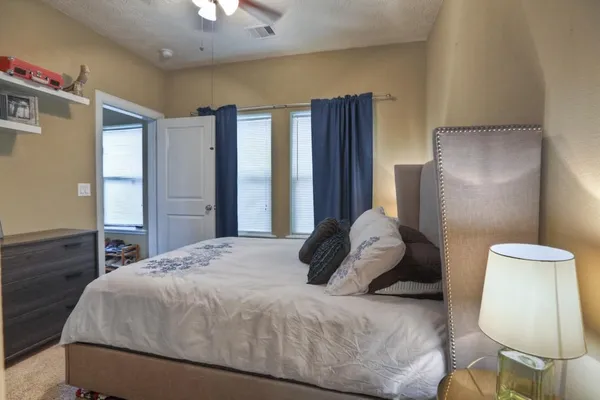 a bedroom with a bed and a mirror