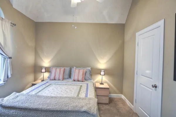 a bed room with a bed and a night stand
