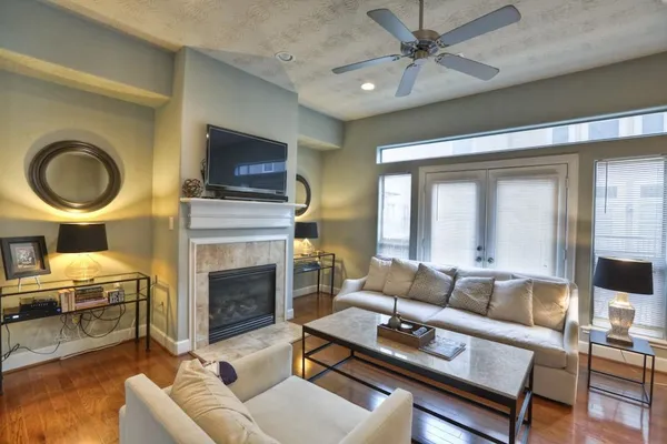 a living room with furniture a flat screen tv and a fireplace