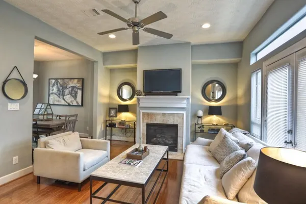 a living room with furniture a clock and a fireplace