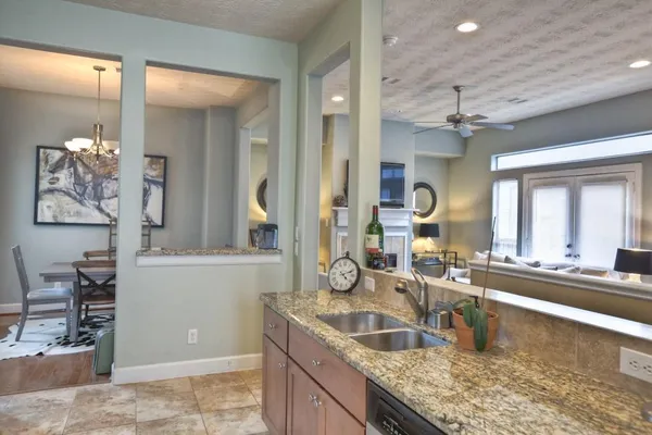 a kitchen with granite countertop a sink and a stove