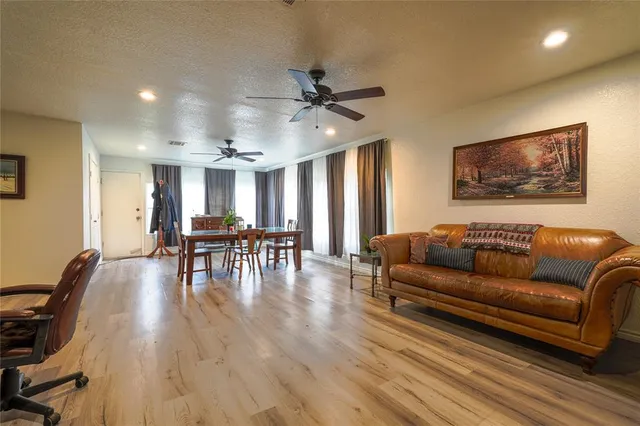 a living room with furniture and wooden floor