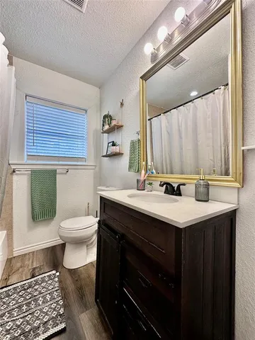 a bathroom with a sink toilet and mirror