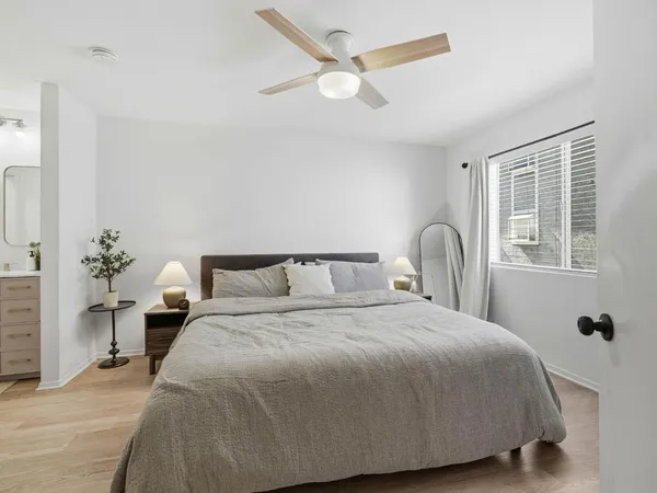 a spacious bathroom with a double vanity sink toilet mirror and shower
