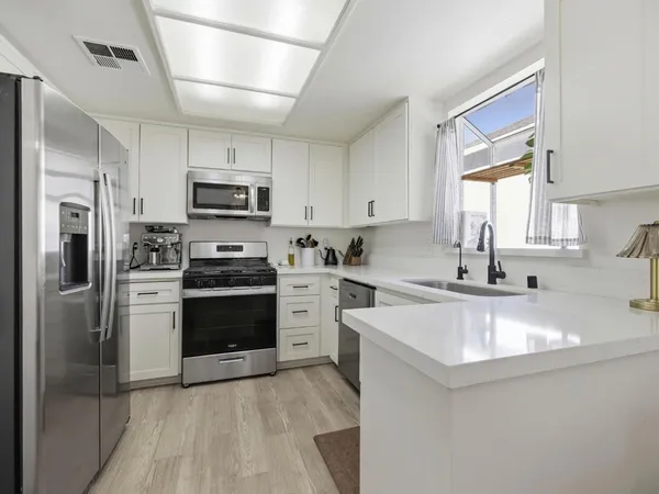 a view of a dining room with furniture and a window