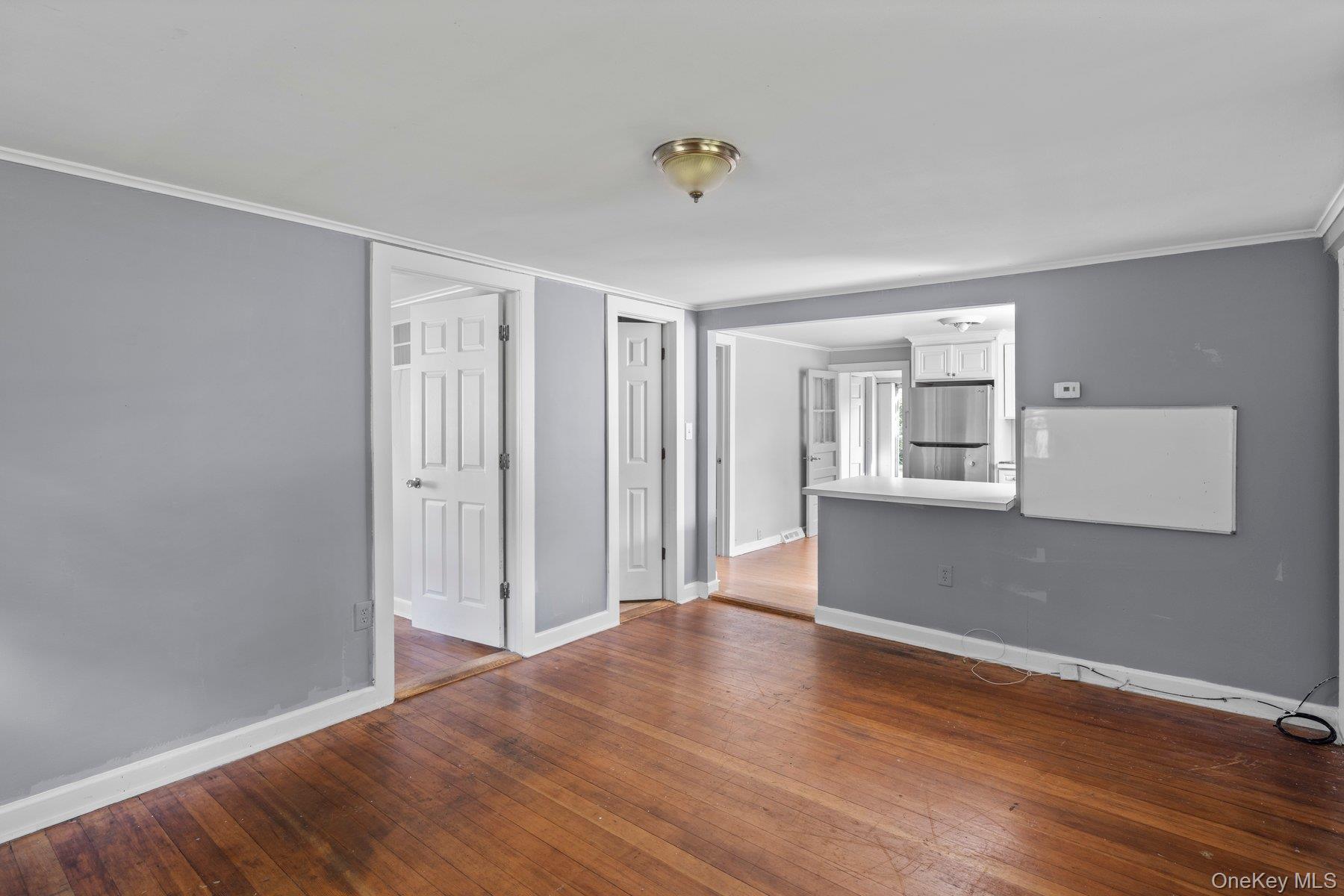 39-41 Foster Road Quogue, NY 11959 - Photo 12 of 13 a view of an empty room with wooden floor and a window