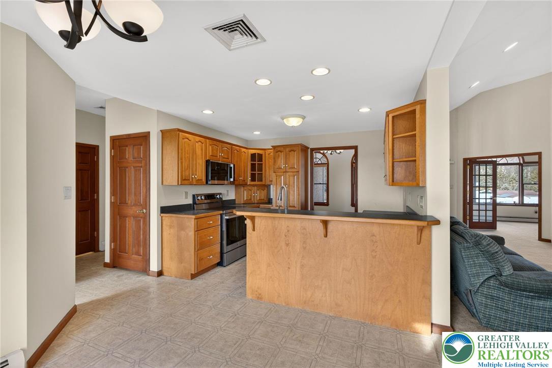 3338 Spring Valley Road Slatington, PA 18080 - Photo 27 of 53 a large kitchen with stainless steel appliances granite countertop a refrigerator and a stove top oven