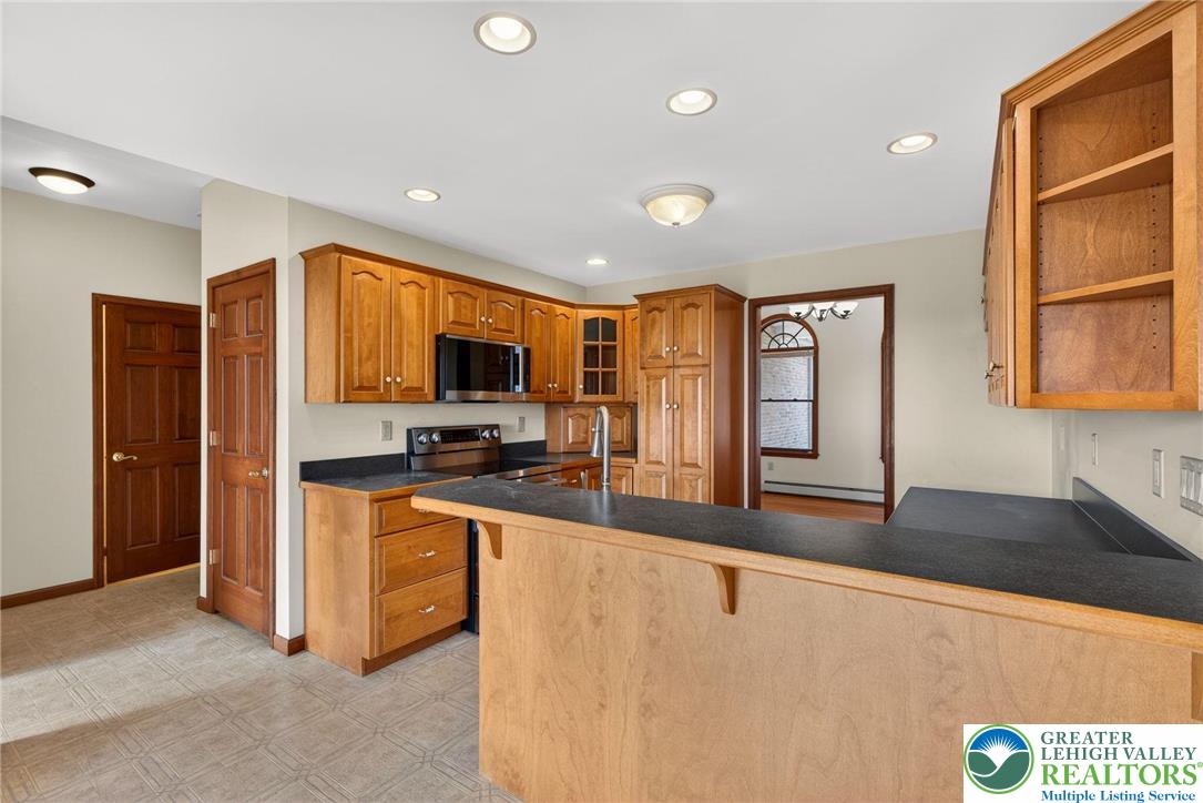 3338 Spring Valley Road Slatington, PA 18080 - Photo 28 of 53 a large kitchen with stainless steel appliances a large counter top a stove and a refrigerator