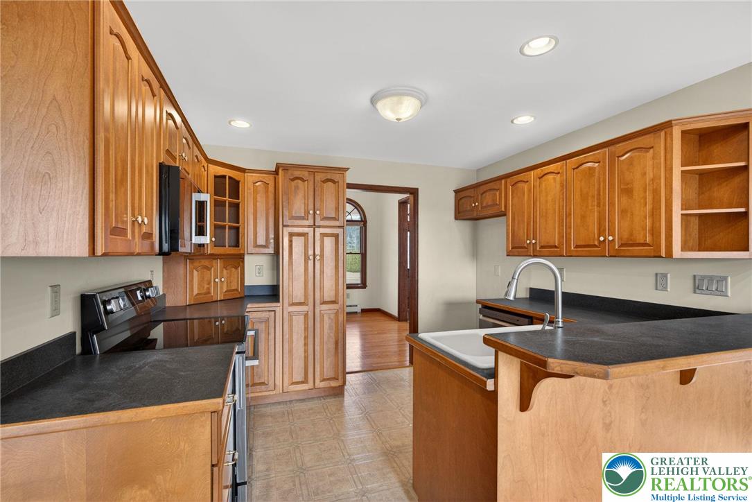 3338 Spring Valley Road Slatington, PA 18080 - Photo 30 of 53 a kitchen with stainless steel appliances granite countertop a sink and a refrigerator