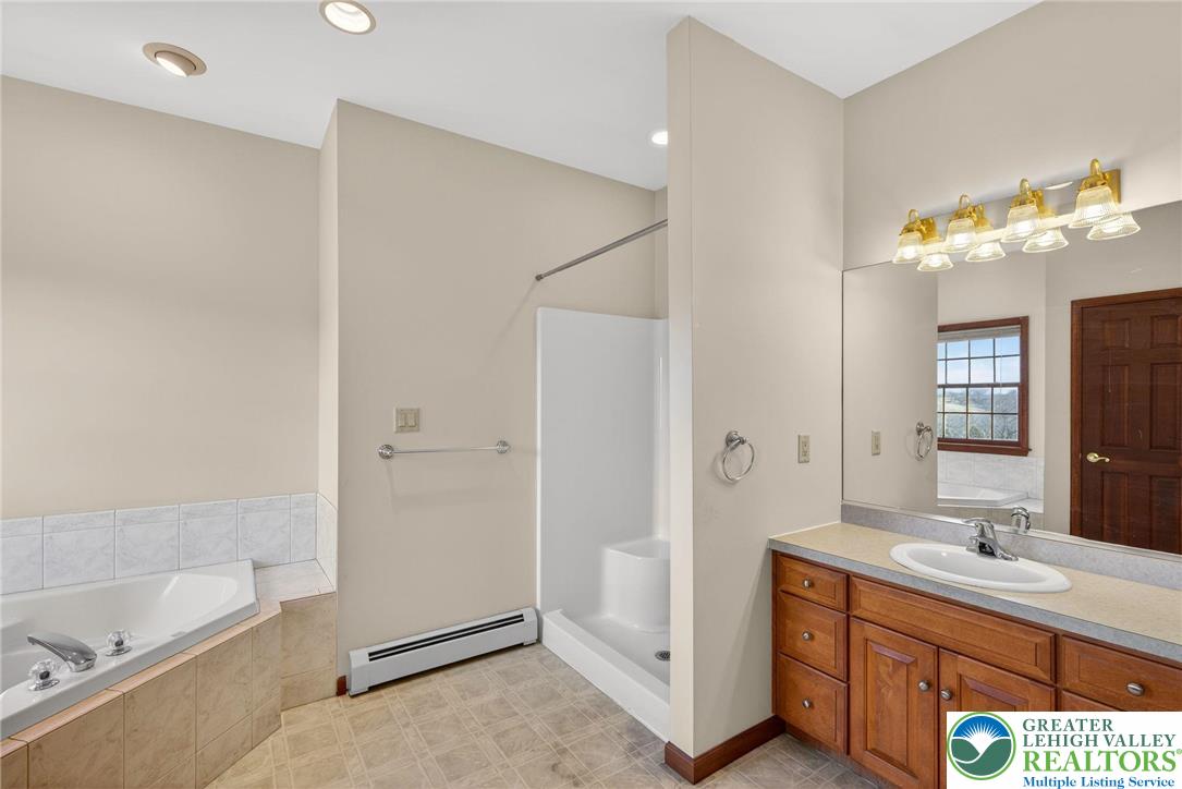 3338 Spring Valley Road Slatington, PA 18080 - Photo 38 of 53 a bathroom with a tub sink and mirror