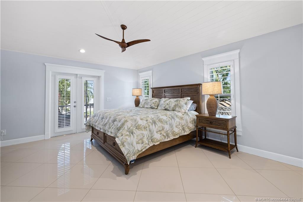 1359 Southwest Dyer Point Road Palm City, FL 34990 - Photo 18 of 55 a bedroom with a bed and a window