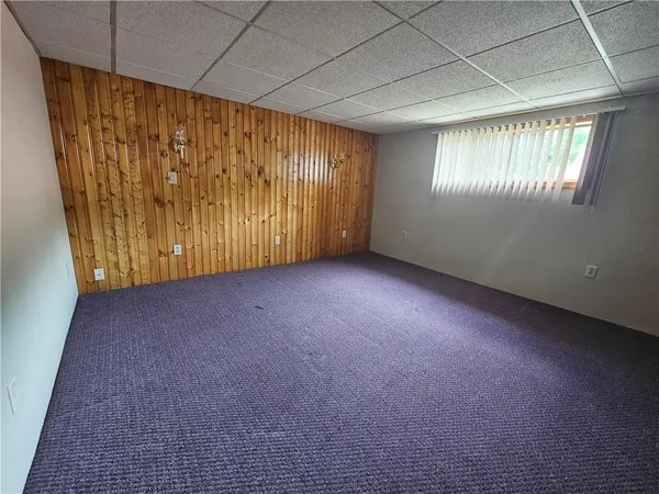 a view of empty room with window and fireplace