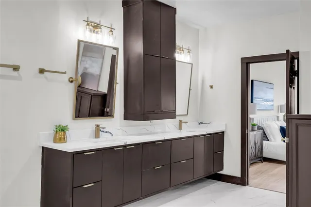 a en suite bathroom with a double vanity sink double and mirror