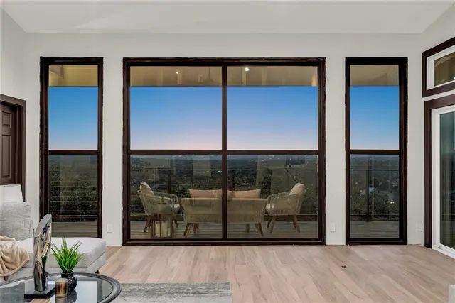 a view of a glass door with a balcony and door