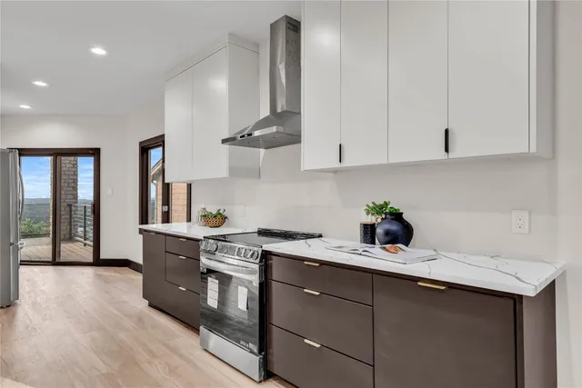 a kitchen with a sink a stove and cabinets