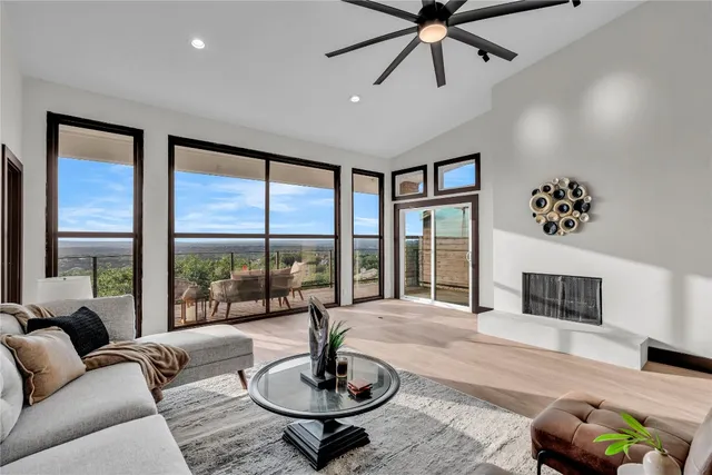 a living room with furniture and a floor to ceiling window