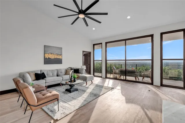 a living room with furniture large windows and a flat screen tv