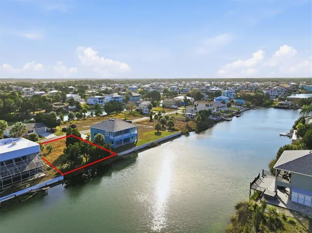an aerial view of residential houses with outdoor space and ocean view