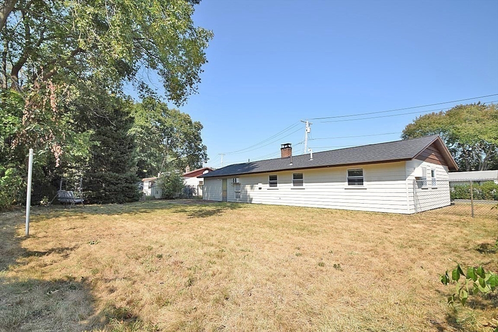 22 Devine Road Randolph, MA 02368 - Photo 26 of 27 a view of white house with a big yard and large tree