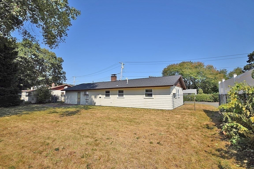 22 Devine Road Randolph, MA 02368 - Photo 3 of 27 a view of a house with a big yard and large trees