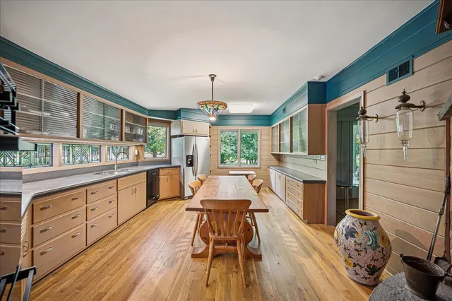 a kitchen with wooden floors a sink and a stove