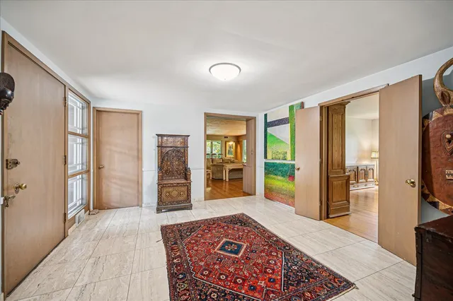 a view of a hallway with furniture and a window