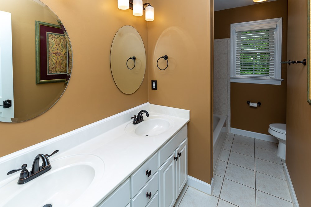 2728 Sunnystone Way Raleigh, NC 27613 - Photo 22 of 30 a bathroom with a sink and a mirror