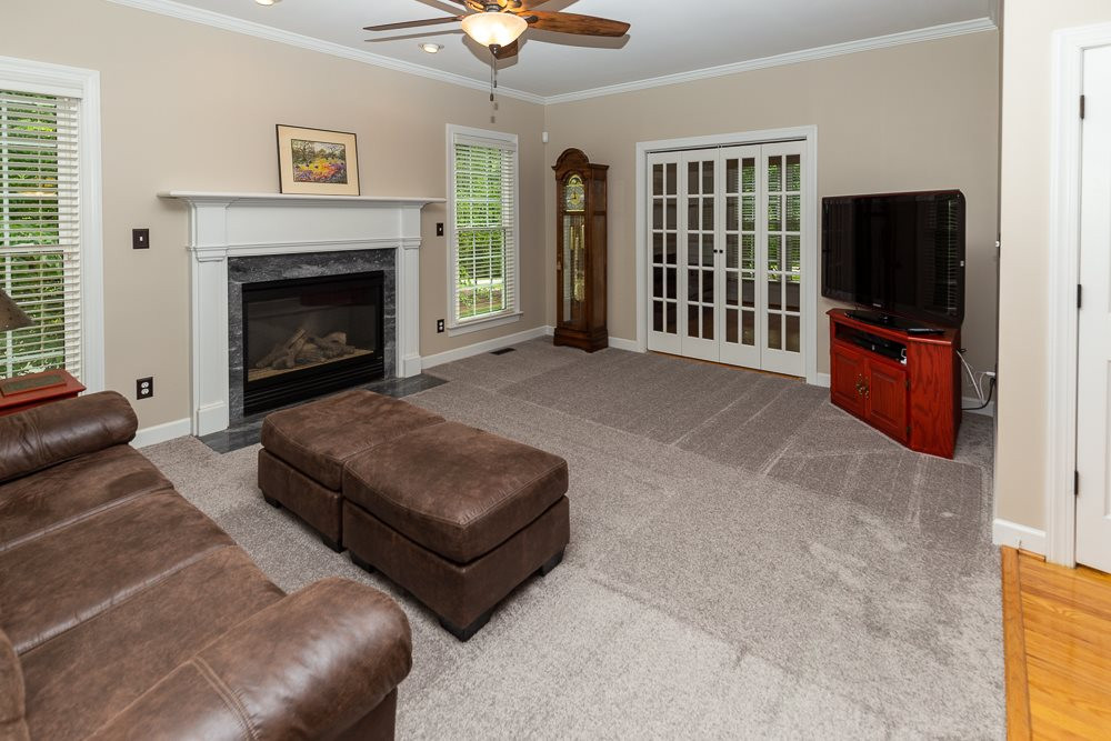 2728 Sunnystone Way Raleigh, NC 27613 - Photo 3 of 30 a living room with furniture and a fireplace