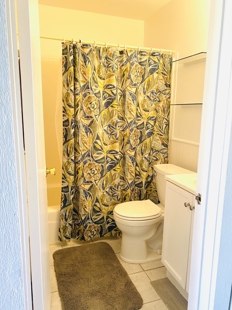 47 Nassau Colony, Unit 1 Fox Lake, IL 60020 - Photo 6 of 13 a bathroom with a toilet and a shower curtain