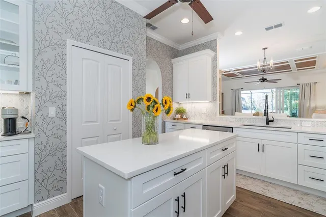 a kitchen with a sink dishwasher and a refrigerator