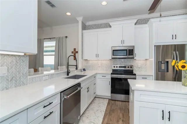 a kitchen with a sink stove and microwave