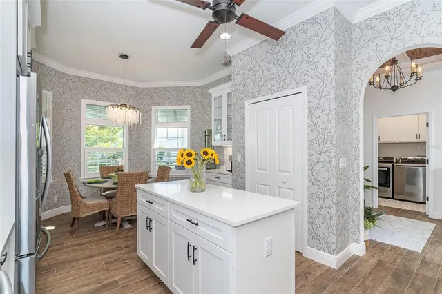 a kitchen with sink cabinets and wooden floor