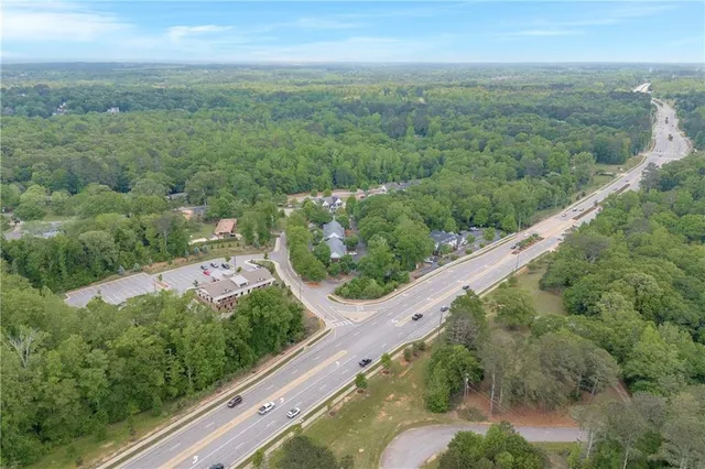 an aerial view of a house with yard