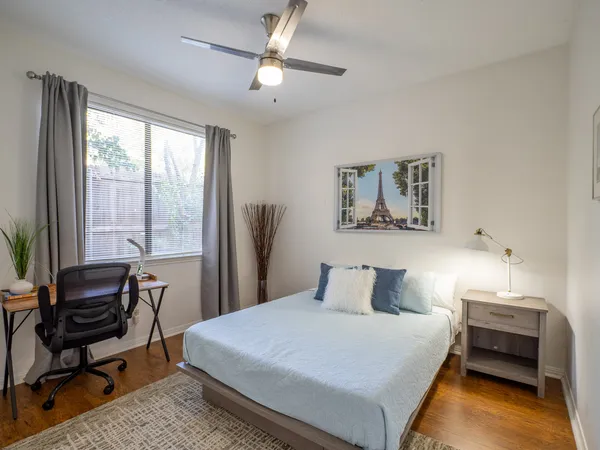 a bedroom with a bed a desk and chair