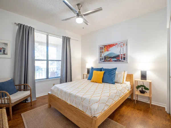 a bedroom with a bed and a window