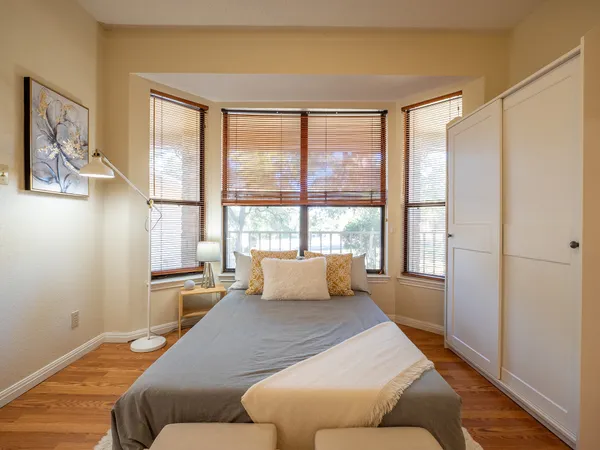 a bedroom with a large bed and a window