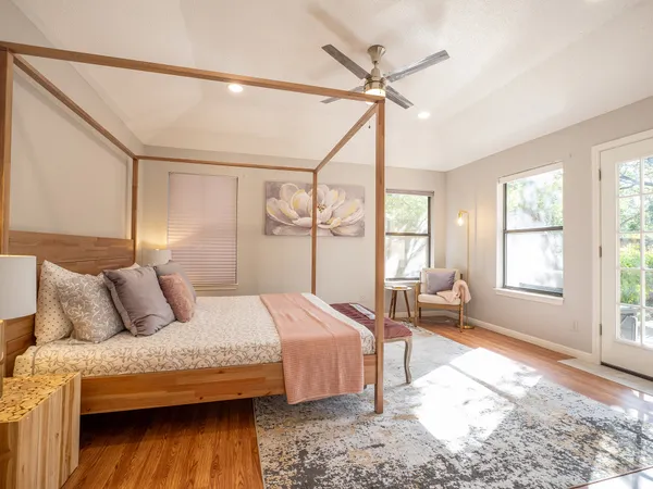 a bedroom with a bed and wooden floor