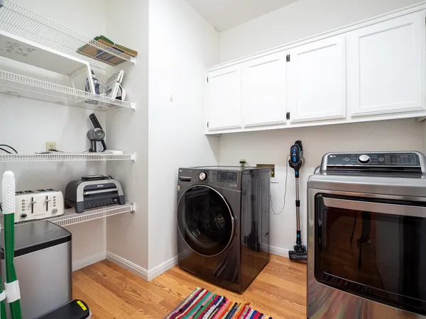 a utility room with sink dryer and washer