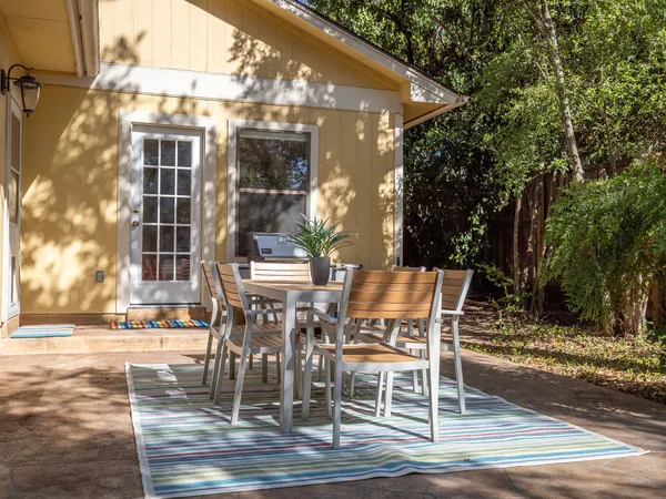 a view of a patio with table and chairs and potted plants