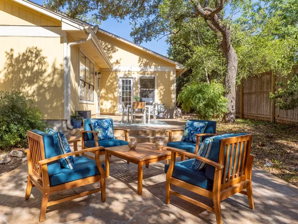 a view of a patio with table and chairs and potted plants