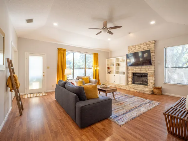 a living room with furniture a fireplace and a flat screen tv