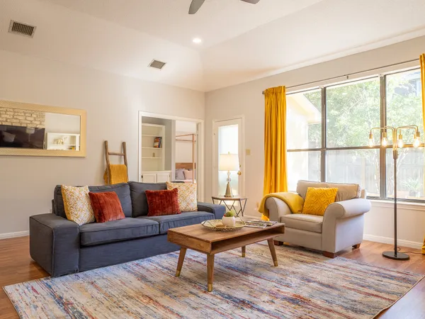 a living room with furniture and a large window