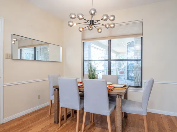 a view of a dining room with furniture window and wooden floor