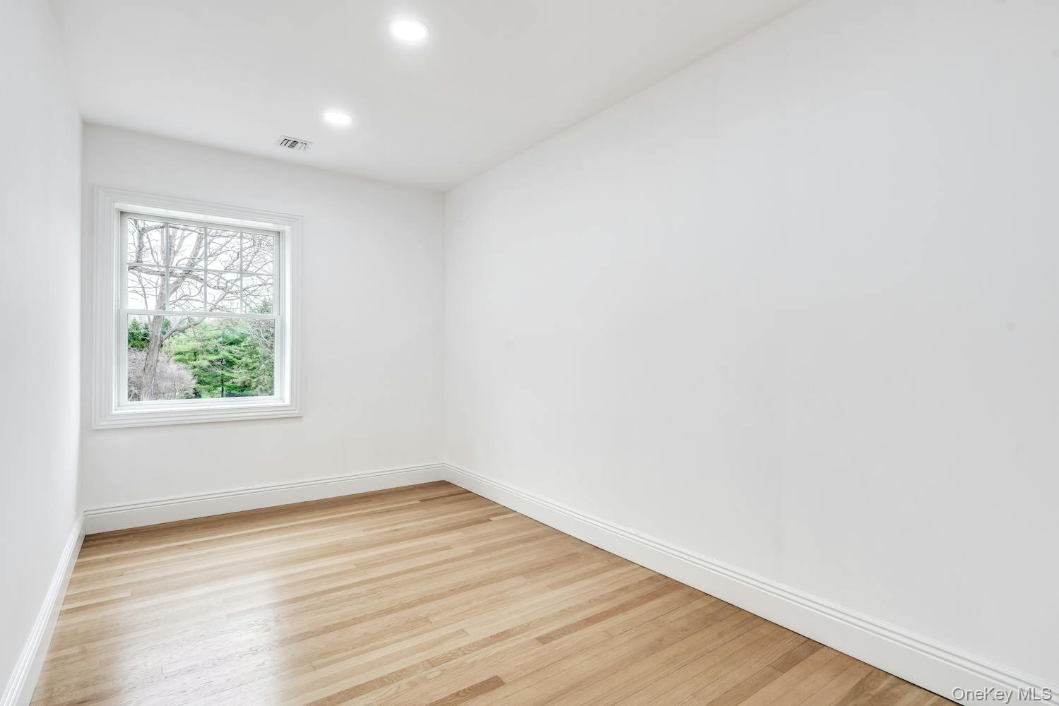 539 Split Rock Road Syosset, NY 11791 - Photo 21 of 40 Spare room with visible vents, recessed lighting, light wood-style flooring, and baseboards