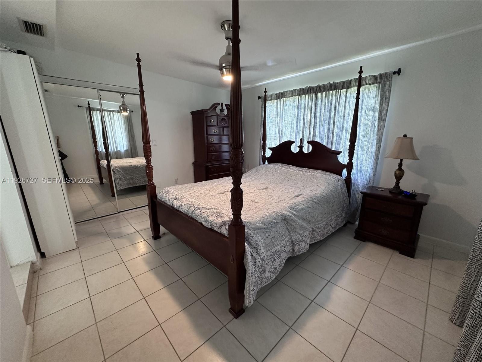 165 Southwest 130th Avenue Miami, FL 33182 - Photo 18 of 20 a bedroom with a bed and a mirror