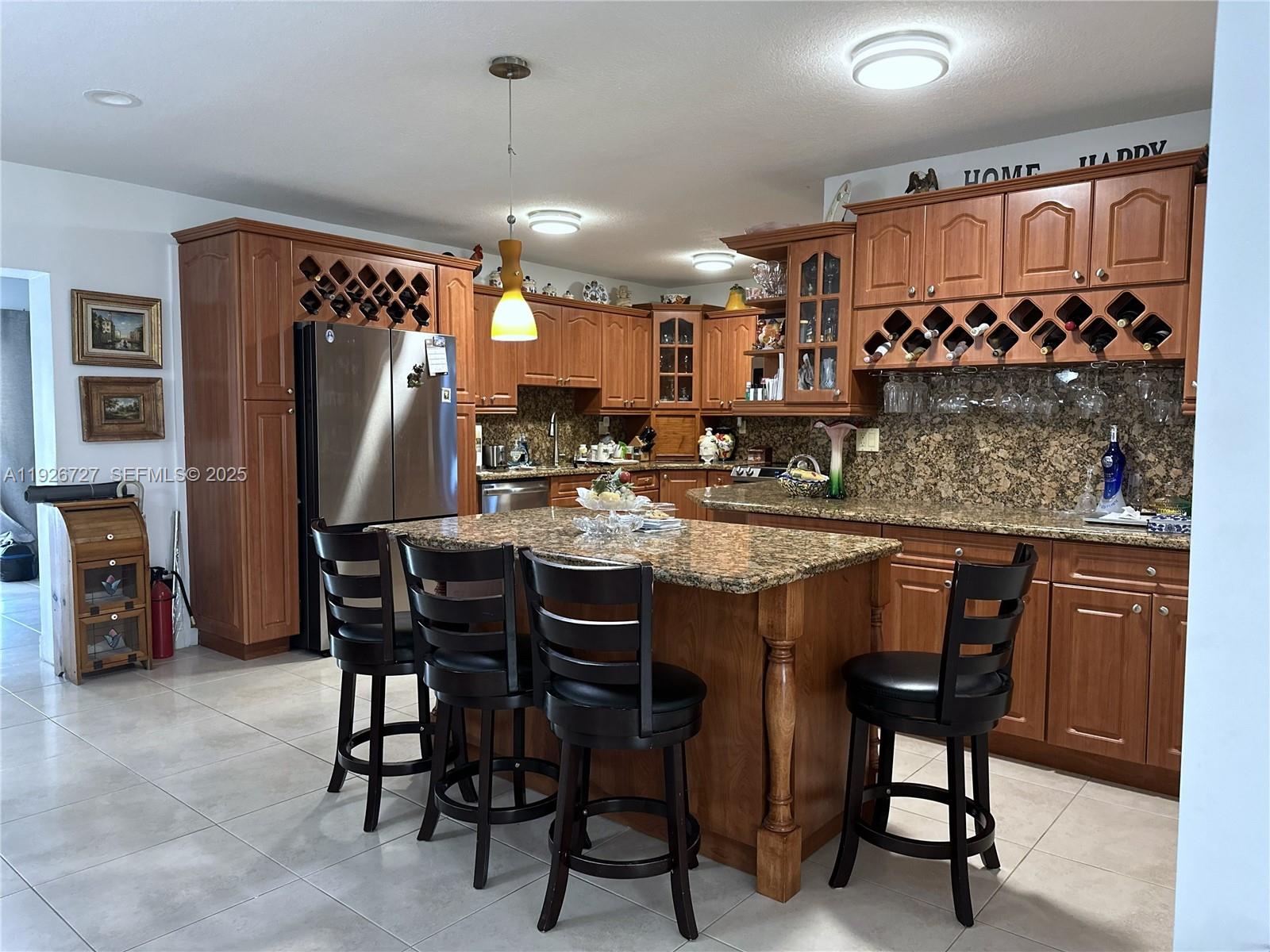 165 Southwest 130th Avenue Miami, FL 33182 - Photo 6 of 20 a dining table chairs and a refrigerator