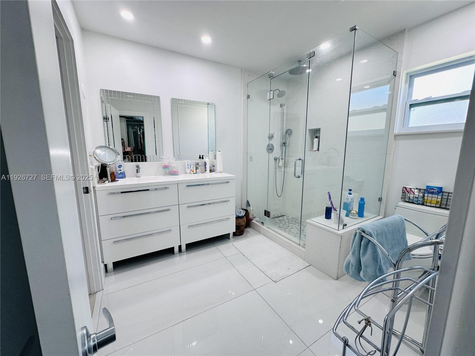 165 Southwest 130th Avenue Miami, FL 33182 - Photo 9 of 20 a living room with furniture and a chandelier